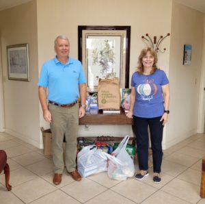 Attorney Grady and Marketing Manager and Executive Assistant Paula Emery with food donations 