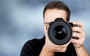 Male Photographer Holding Camera