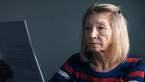 Elderly woman looking at a computer 
