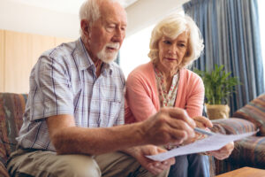 Senior couple worried looking at a bill