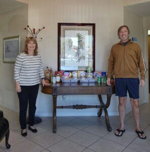 Marketing Manager and Executive Assistant, Paula Emery and Public Relations and Social Media Manager, Andrew Paul Williams, Ph.D. are pictured in our office with donations for this year's Thanksgiving Food Drive for The Food Pantry of Green Cove Springs.