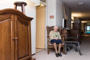 Elderly woman being transferred out of her assisted living apartment